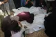 Palestinian mourners take a last look at the bodies of members of the al-Amasi family, who were killed by Israeli air strike, during their funeral in Deir al-Balah, Gaza Strip, July 21, 2026