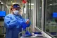 A nurse puts on PPE in a ward for Covid patients at King's College Hospital, in south east London, December 21, 2021