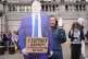 A woman holds a cardboard cut out of Prime Minister Sir Keir Starmer, as people gather in Trafalgar Square on Saturday afternoon ahead of a demonstration against the ban on Palestine Action