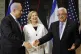 Palestinian President Mahmoud Abbas shakes hands with Israel