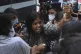 A woman reacts as police detain activists protesting against