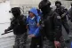 Riot police detain a supporter of Movement Towards Socialism