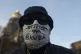 A man wears a protective face mask as he attends a solidarit