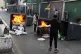 Protesters burn garbage containers to block a road in Beirut