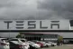 Vehicles are parked outside the Tesla plant, in Fremont, Cal