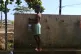 A boy fills up a bottle at the water fountain in M'tsamoudou