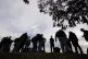 Migrants stand in groups as they arrive at a bus stop after 