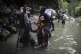 Haitian migrants wade through water as they cross the Darien