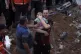 A Palestinian man cries while holding a dead child who was f