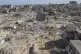 Palestinians walk through the destruction left by the Israel