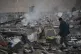 Security personnel inspect the site reportedly struck by US 