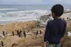 Palestinians inspect the rubble of a structure hit by an Isr