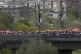 Hundreds of people march across a bridge in Yerevan carrying