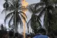 Onlookers watch an oil well burn after it was caught fire in