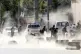 Security forces run from the site of a suicide attack after 