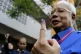 Malaysian Prime Minister Najib Razak shows his finger marked