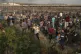 Palestinian protesters run from tear gas fired by Israeli so