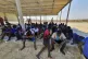 Rescued migrants rest near the city of Al Khoms, around 75 m