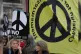 Anti war demonstrators hold banners as they protest outside 