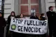 Activists block the doors to the headquarters of fossil fuel