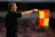 Detailed view of the linesman's flag as he raises it to sign