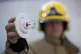 A firefighter holds up a sprinkler