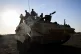 British troops sit atop a tank in the neighbouring absolute 