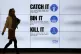 An NHS catch it, bin it, kill it sign on TV screens in the e