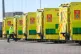 A paramedic walks past parked ambulances as they await the f