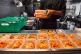 Kitchen staff at a pub preparing free packed lunches for kid