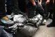 A man kneels on the statue of slave trader Edward Colston be