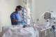 A nurse checking on a patient suffering with Covid-19 on the