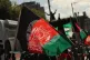 People waving Afghan flags attend a protest against Taliban 