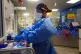 A nurse puts on PPE on a ward for Covid patients at King's C