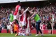 Arsenal's Granit Xhaka (on knees) is mobbed by team-mates af