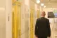 An employee walks past cell doors in a wing of Harmondsworth