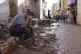 A volunteer rests during a clean-up in an area affected by 